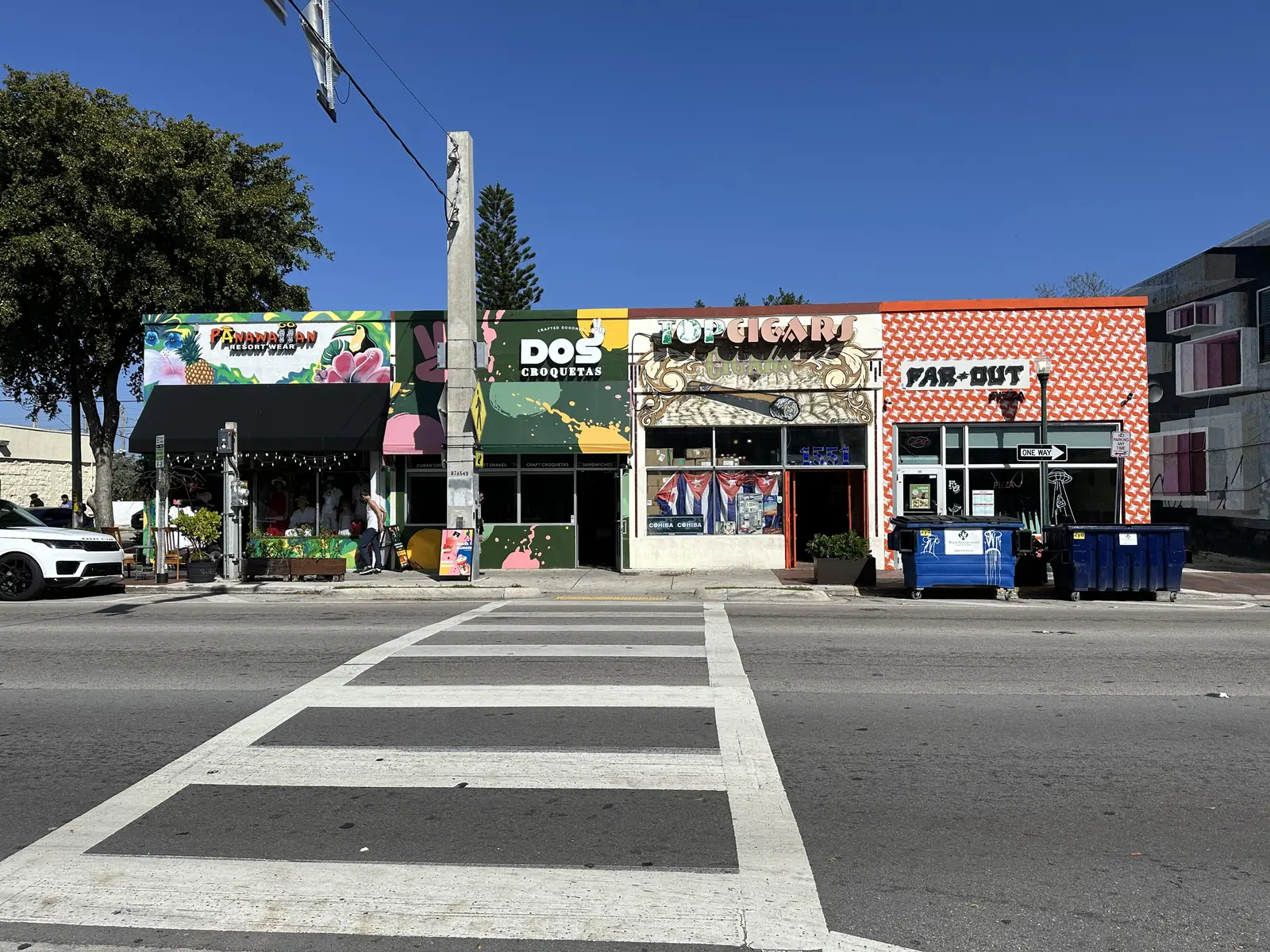 Shop fronts and a crosswalk on Calle Ocho in Little Havana, the street the festival fills each March.