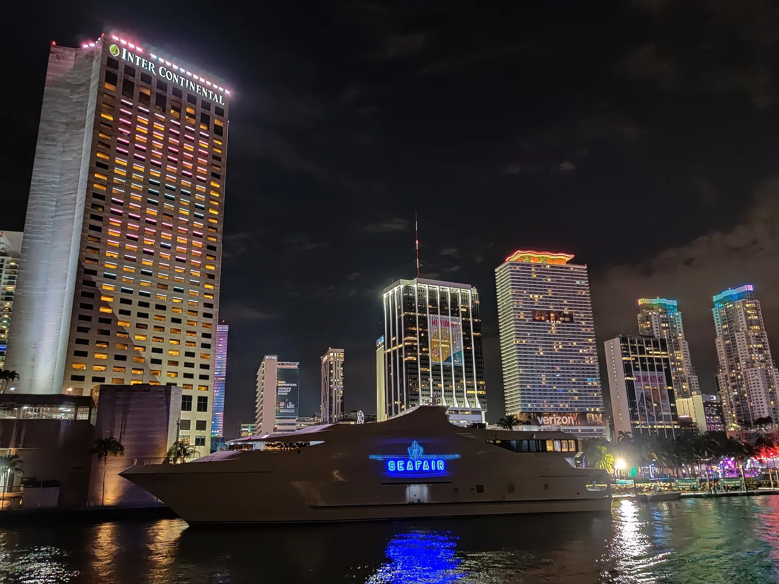 The InterContinental Miami, left, lit up at night above the mouth of the Miami River in downtown Miami.