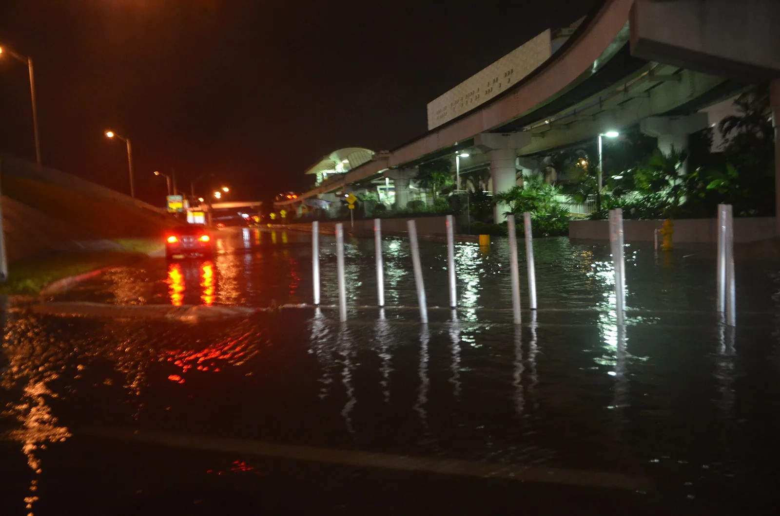 A flooded street in Miami during a king tide with rain.