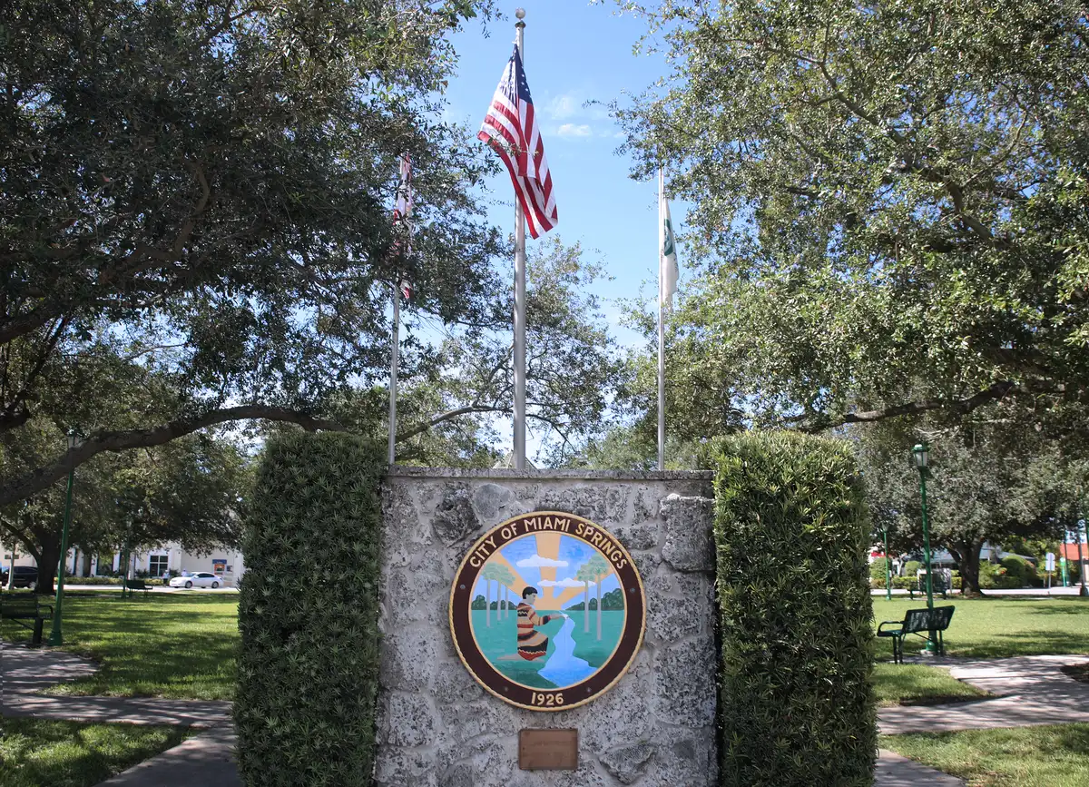 The City of Miami Springs seal on a coral rock marker in a park in Miami Springs.