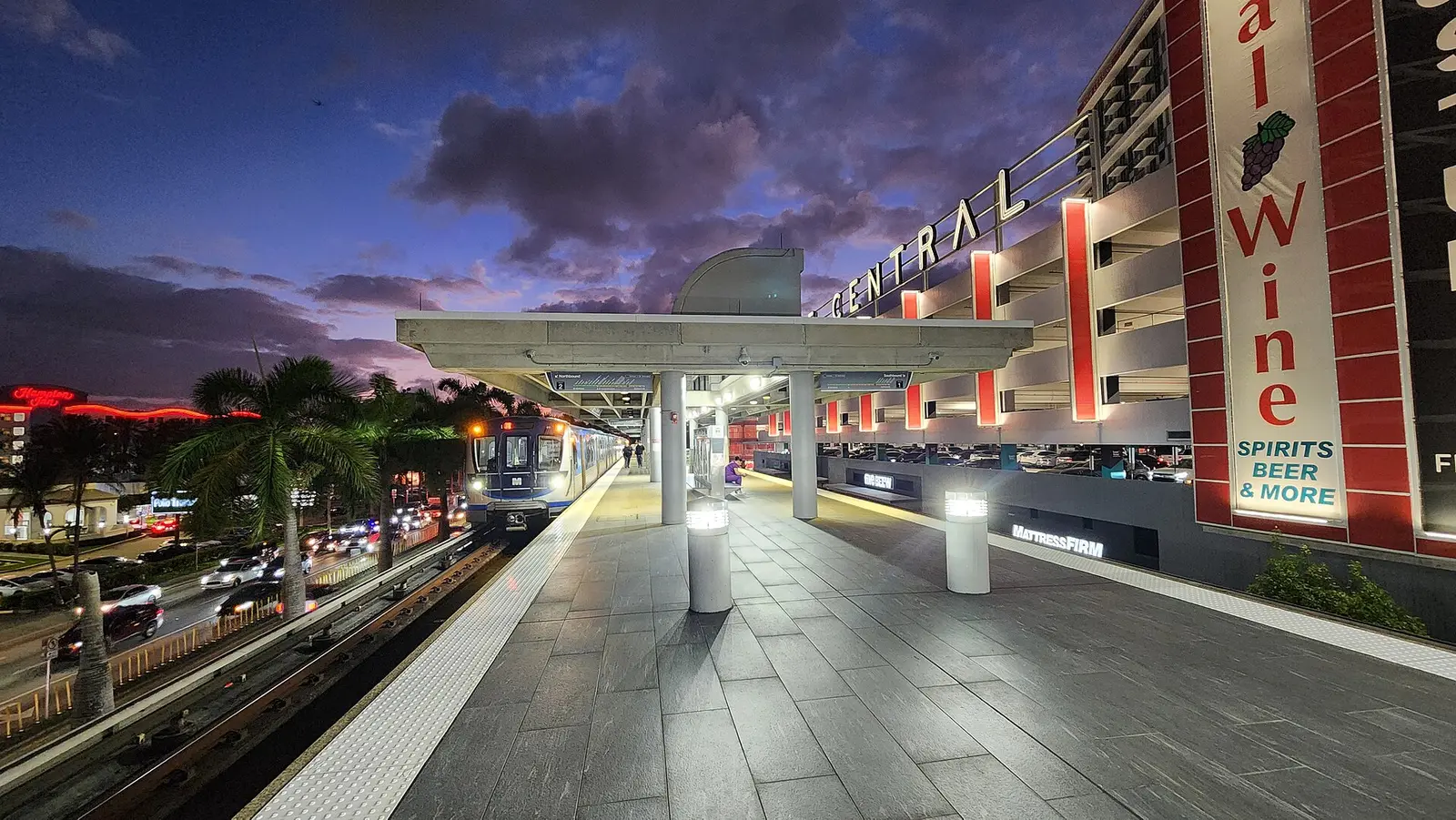 A Metrorail train at the Coconut Grove station platform at sunset, in the Coral Way area of Miami.