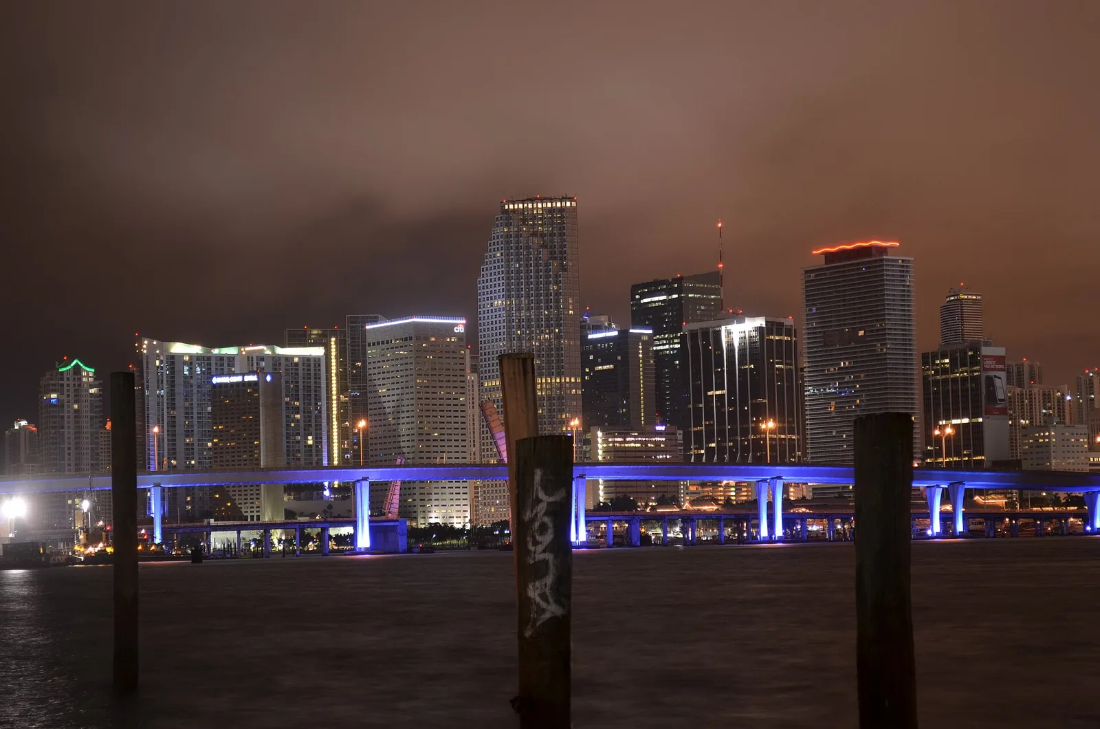 Downtown Miami lit up at night, seen across Biscayne Bay.